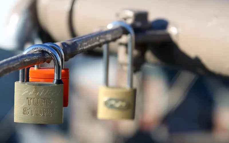 Padlocks attached to a metal fence