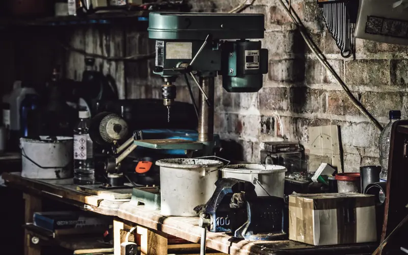 Workshop bench crowded with tools and machinery