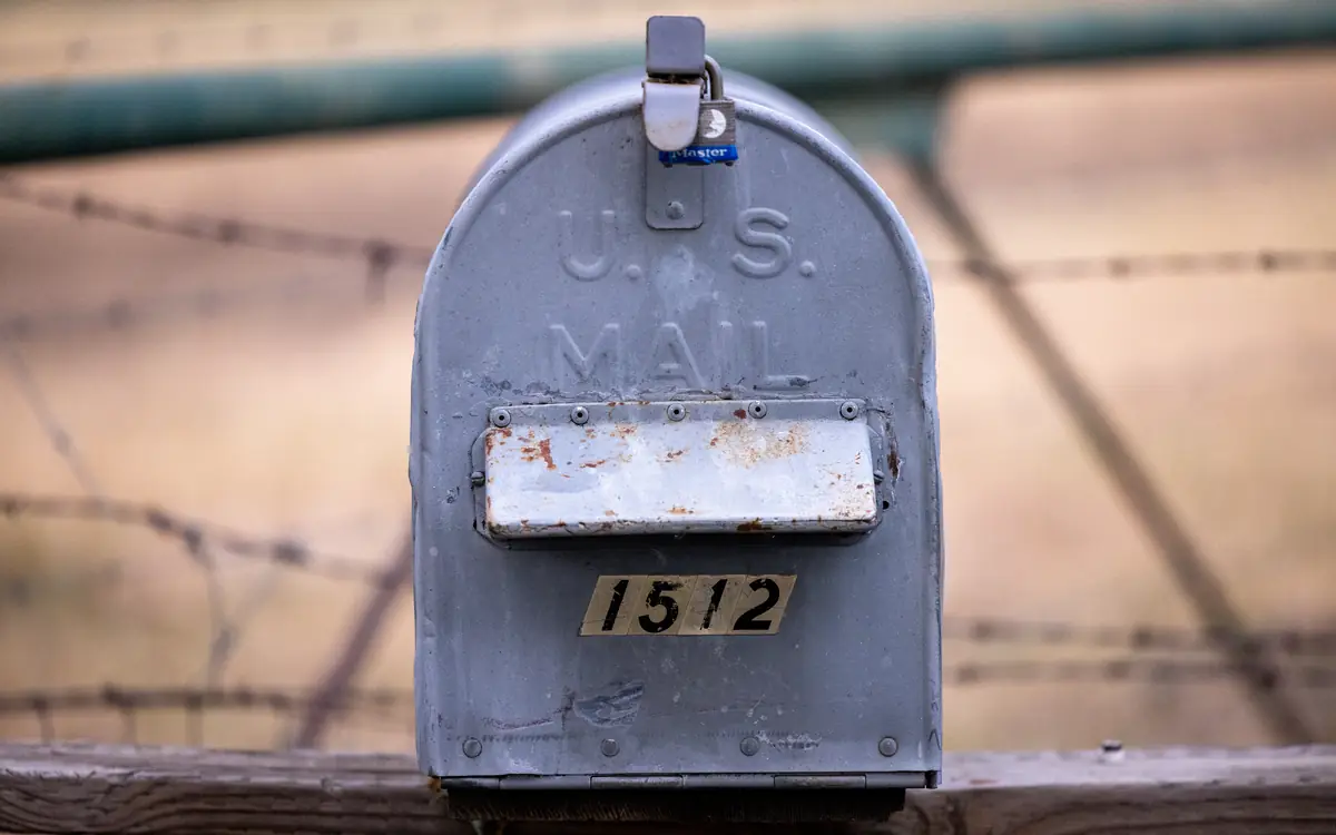 Grey metal mailbox on a post outdoors