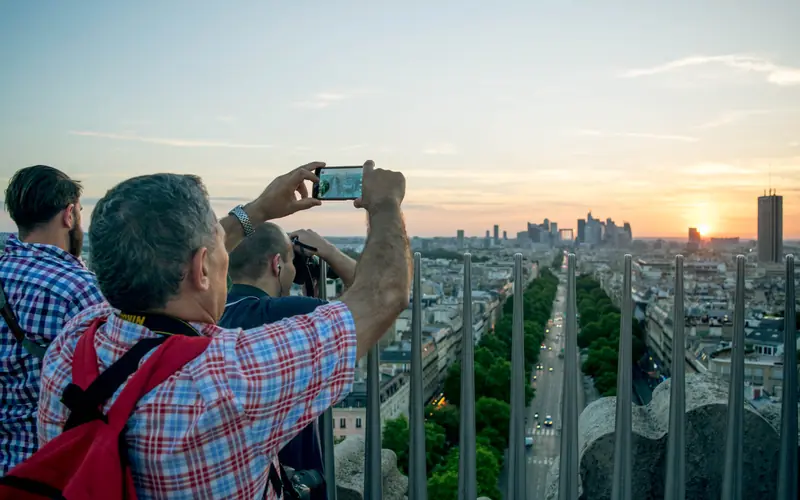 Tourists photographing a city view with a phone