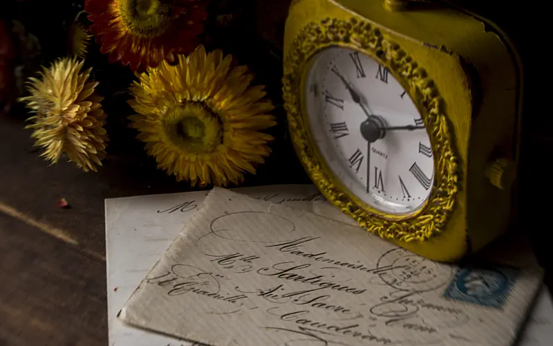 Antique clock beside a handwritten letter