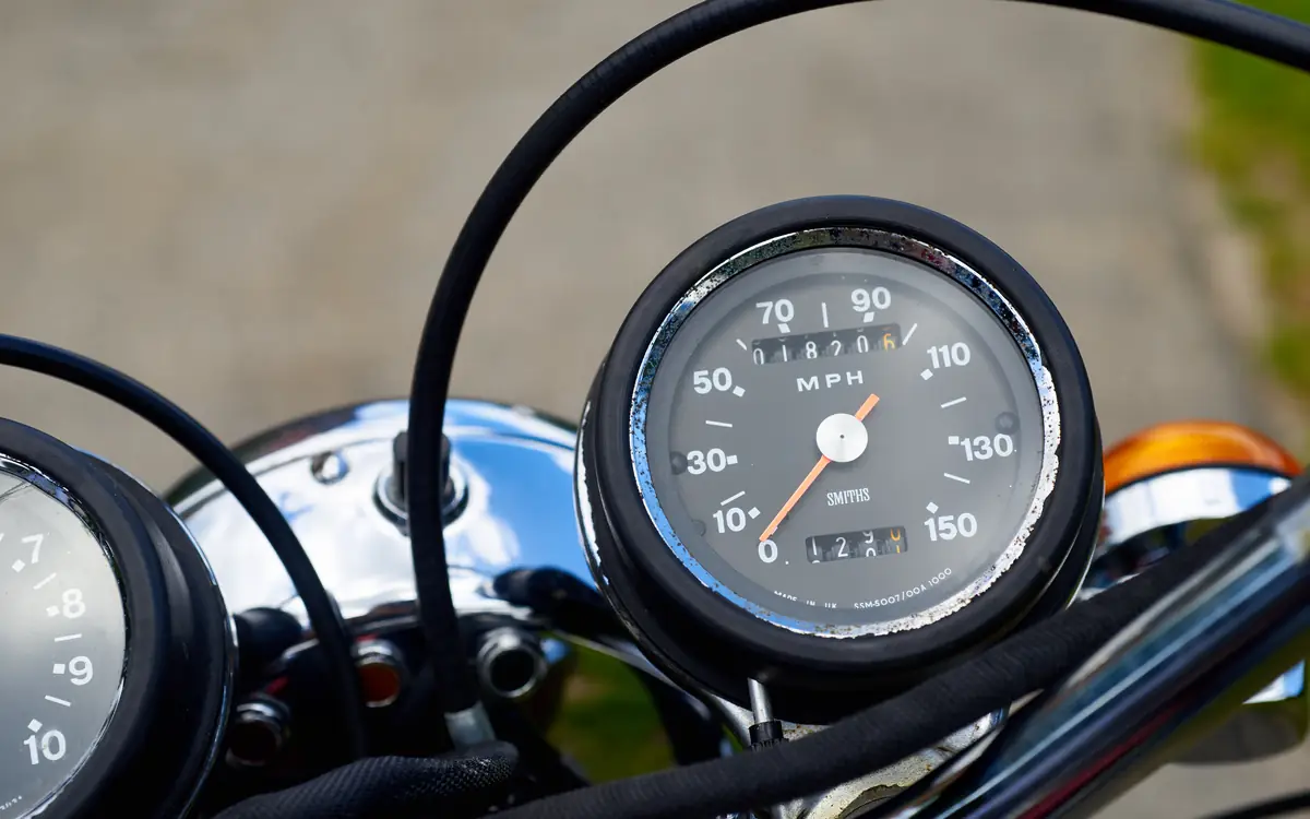 Close-up of a motorcycle speedometer and handlebars