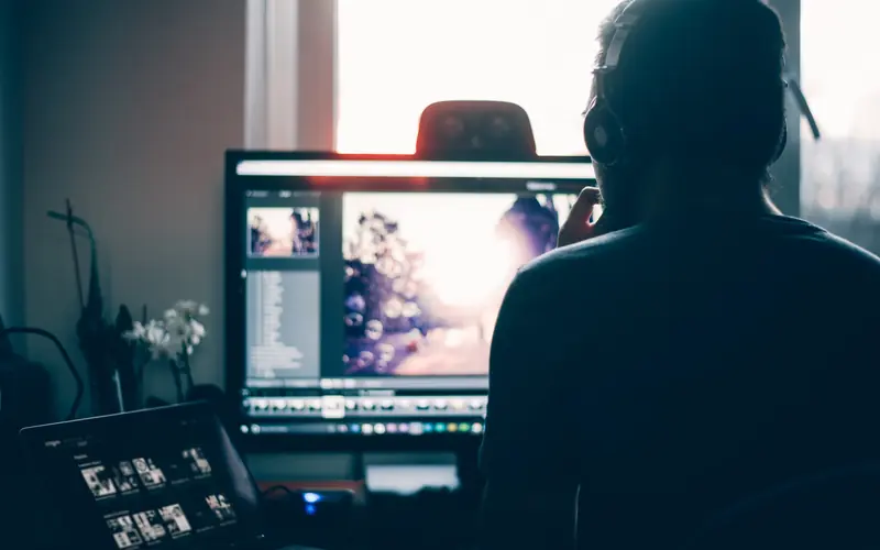 Photo editor working on images on a large monitor
