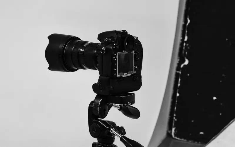 Camera mounted on a tripod in a studio