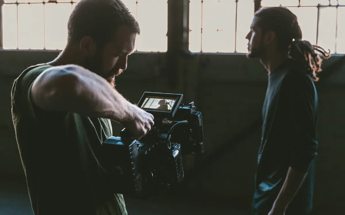 Film crew operating a video camera on a production set