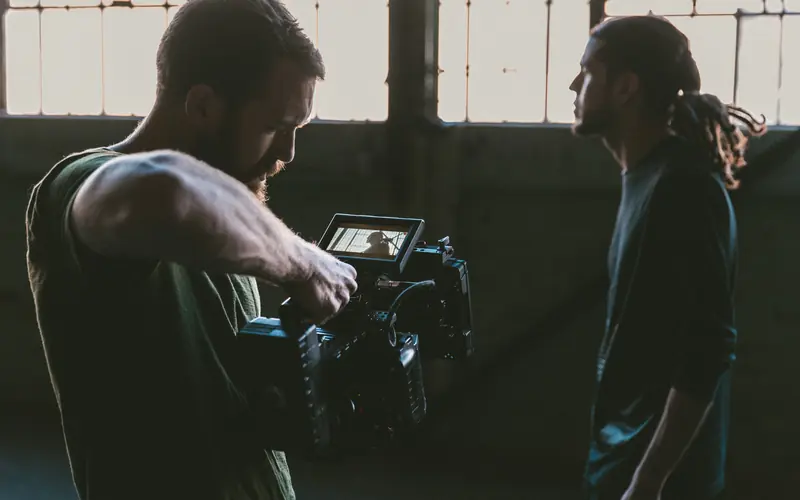 Film crew operating a video camera on a production set